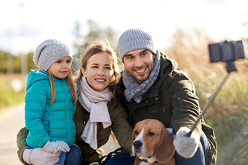 Image showing happy family with dog taking selfie in autumn