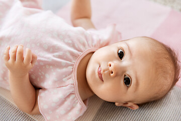 Image showing sweet baby girl lying on knitted blanket