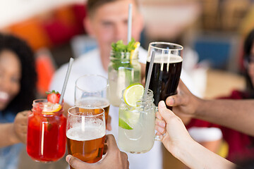 Image showing friends clinking glasses at bar or restaurant