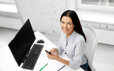 Image showing businesswoman using smartphone at office