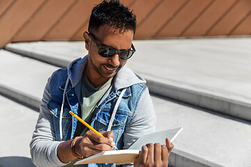 Image showing indian man with notebook or sketchbook on roof top