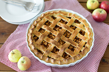 Image showing apple pie in baking mold on wooden table