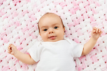 Image showing sweet baby girl lying on knitted plush blanket