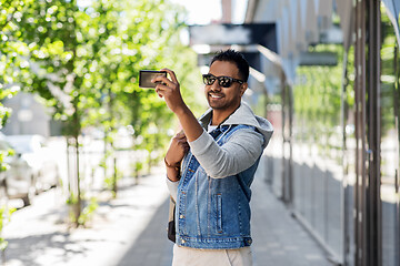 Image showing indian man taking selfie by smartphone in city