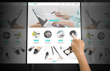 Image showing hand navigating online shop on interactive panel