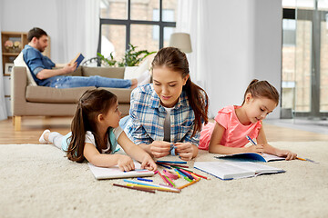 Image showing mother spending time with little daughters at home