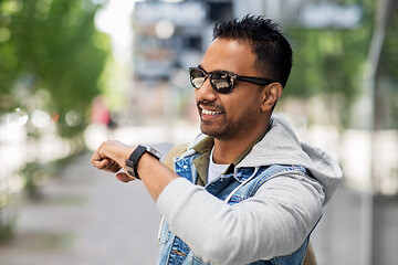 Image showing indian man recording voice message by smart watch