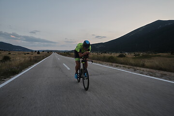 Image showing triathlon athlete riding bike