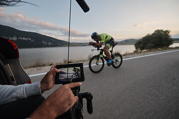 Image showing cinematographer taking action shot of triathlon bike athlete