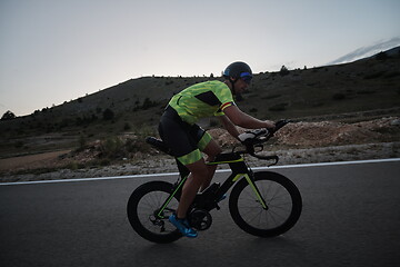 Image showing triathlon athlete riding bike