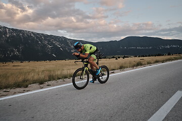 Image showing triathlon athlete riding bike