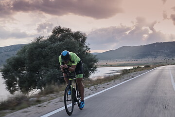 Image showing triathlon athlete riding bike