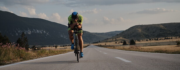 Image showing triathlon athlete riding bike