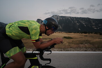 Image showing triathlon athlete riding bike