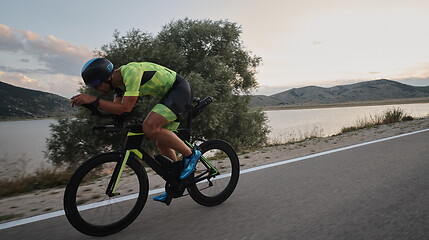 Image showing triathlon athlete riding bike