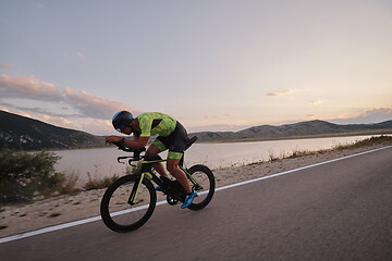 Image showing triathlon athlete riding bike