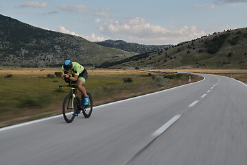 Image showing triathlon athlete riding bike