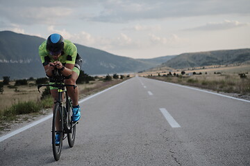 Image showing triathlon athlete riding bike