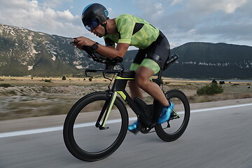 Image showing triathlon athlete riding bike