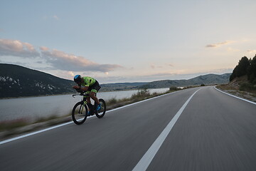 Image showing triathlon athlete riding bike