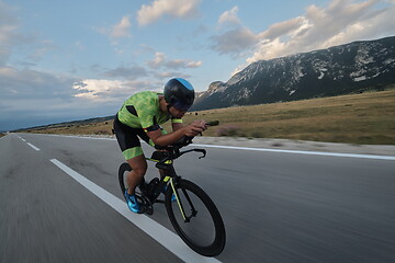 Image showing triathlon athlete riding bike