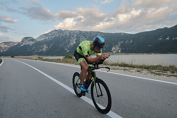 Image showing triathlon athlete riding bike