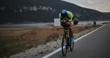 Image showing triathlon athlete riding bike