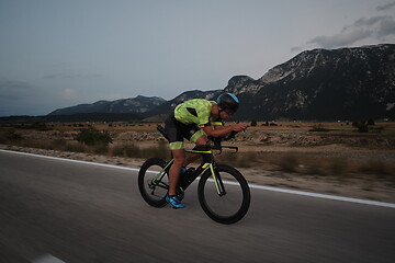 Image showing triathlon athlete riding bike