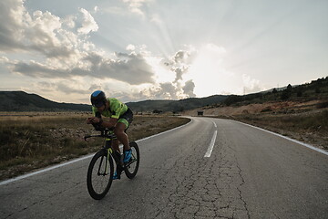 Image showing triathlon athlete riding bike