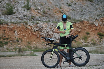 Image showing triathlon athlete riding bike