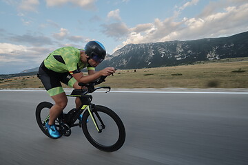 Image showing triathlon athlete riding bike