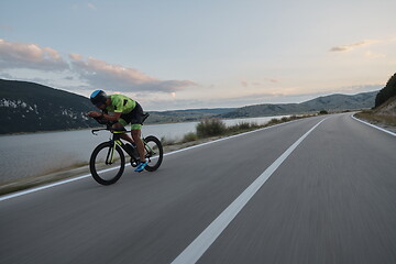 Image showing triathlon athlete riding bike