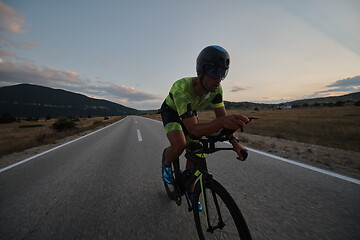 Image showing triathlon athlete riding bike