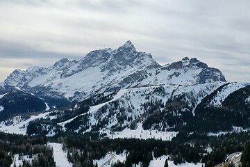 Image showing aerial snow covered mountain peaks in alps at winter 