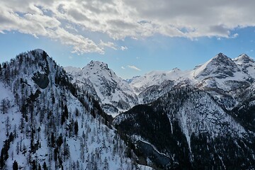 Image showing aerial snow covered mountain peaks in alps at winter 