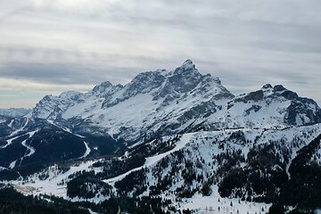 Image showing aerial snow covered mountain peaks in alps at winter 