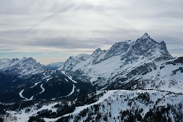 Image showing aerial snow covered mountain peaks in alps at winter 