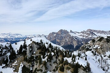 Image showing aerial snow covered mountain peaks in alps at winter 