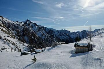 Image showing aerial snow covered mountain peaks in alps at winter 