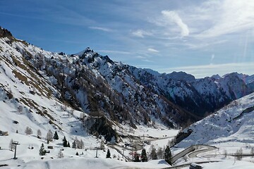 Image showing aerial snow covered mountain peaks in alps at winter 