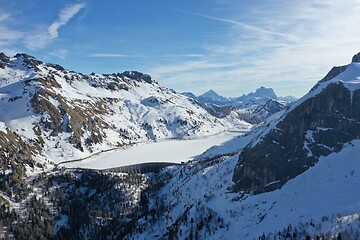 Image showing aerial snow covered mountain peaks in alps at winter 