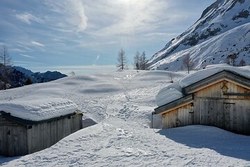 Image showing aerial snow covered mountain peaks in alps at winter 