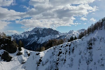 Image showing aerial snow covered mountain peaks in alps at winter 