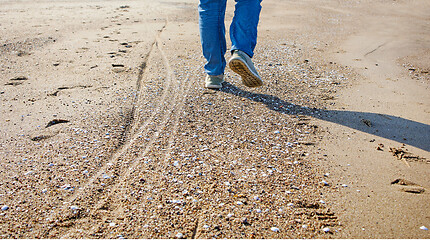 Image showing man walking on the beach