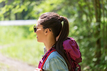 Image showing happy young woman with backpack hiking