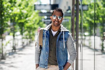 Image showing indian man in sunglasses with backpack in city