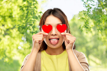 Image showing woman with eyes of hearts over natural background