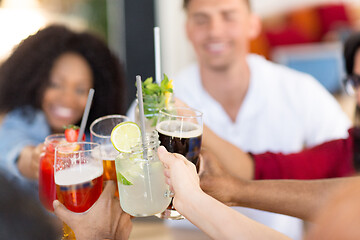 Image showing friends clinking glasses at bar or restaurant