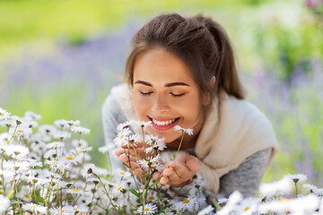 Image showing close up of woman smelling chamomile flowers