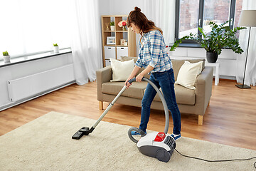 Image showing asian woman with vacuum cleaner at home